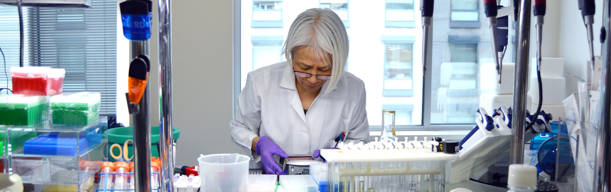 An ALS TDI scientist performing experiments at a lab bench.